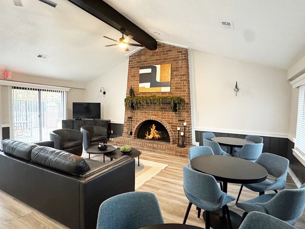 A community building with a fireplace and a TV at Granada Apartments, Jackson