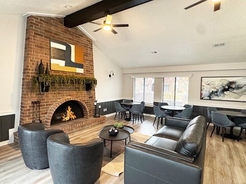 A living room with a fireplace and a painting on the wall.