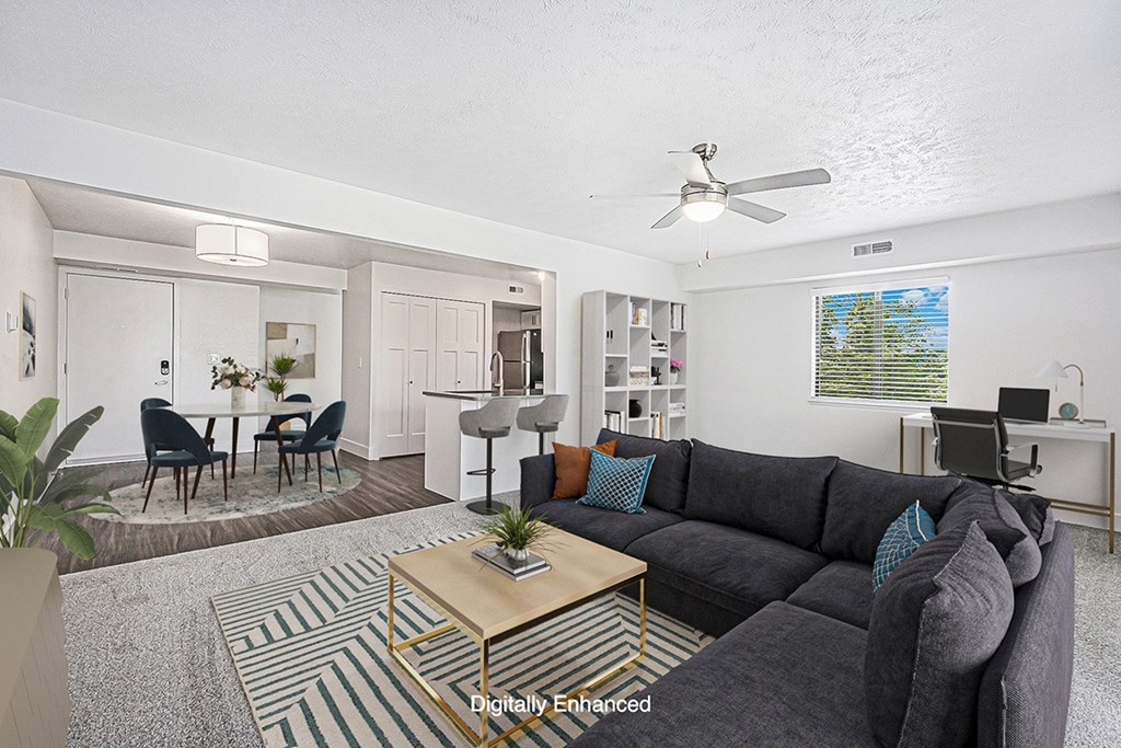 A living room with a grey couch and a coffee table.