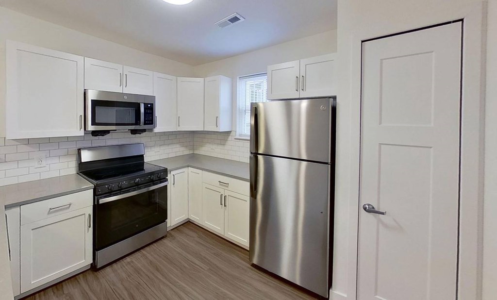 A kitchen with white cabinets at The Grove Apartment Homes, Lincoln, 68512