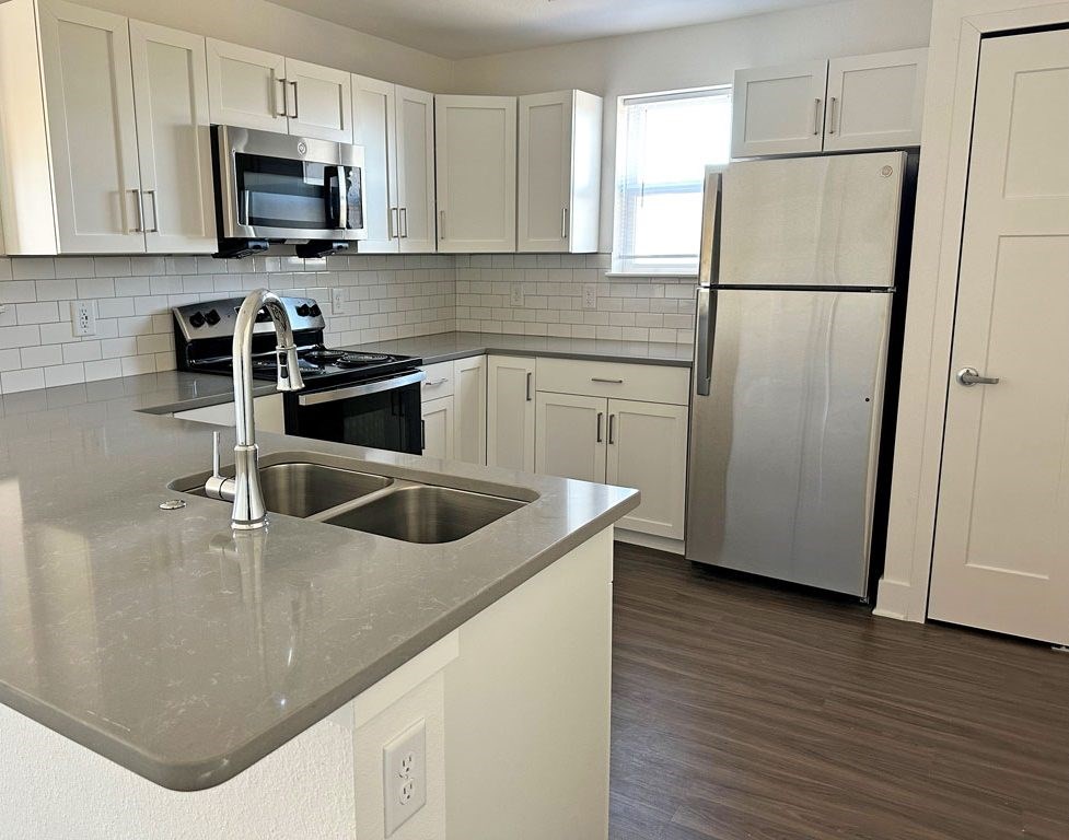An end style kitchen with a window at The Grove Apartment Homes, Lincoln Nebraska