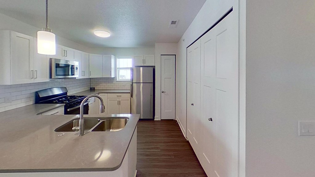 A kitchen with a breakfast bar at The Grove Apartment Homes, Lincoln, 68512