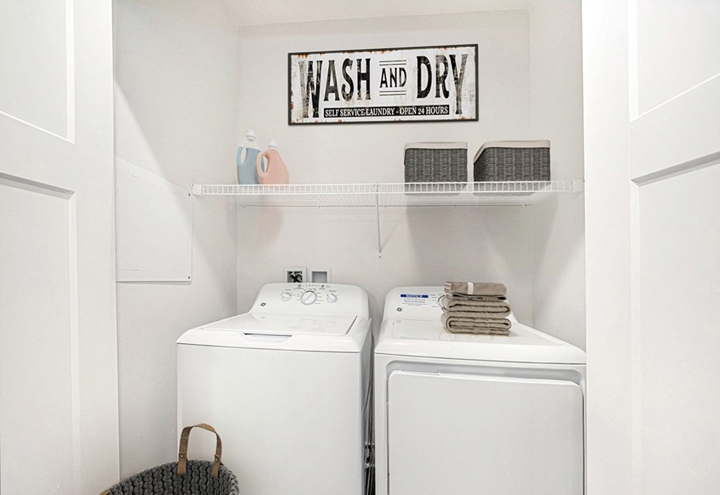 A laundry area with a washer and dryer at The Grove Apartment Homes, Lincoln, NE 68512