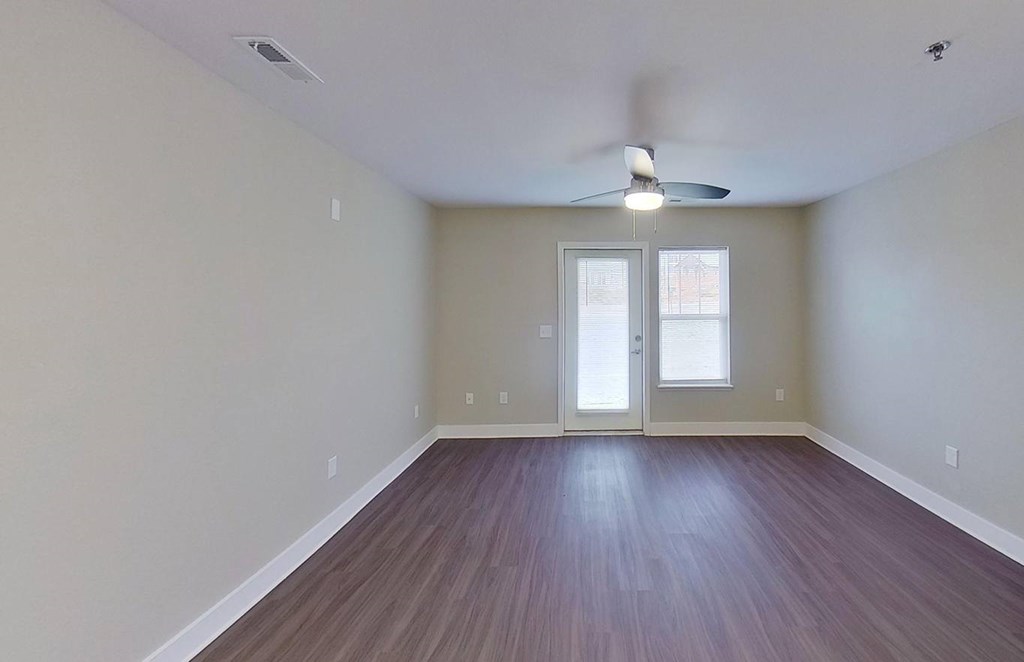 A living room with a ceiling fan at The Grove Apartment Homes, Lincoln