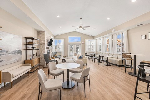 A spacious living room with a dining table and chairs.