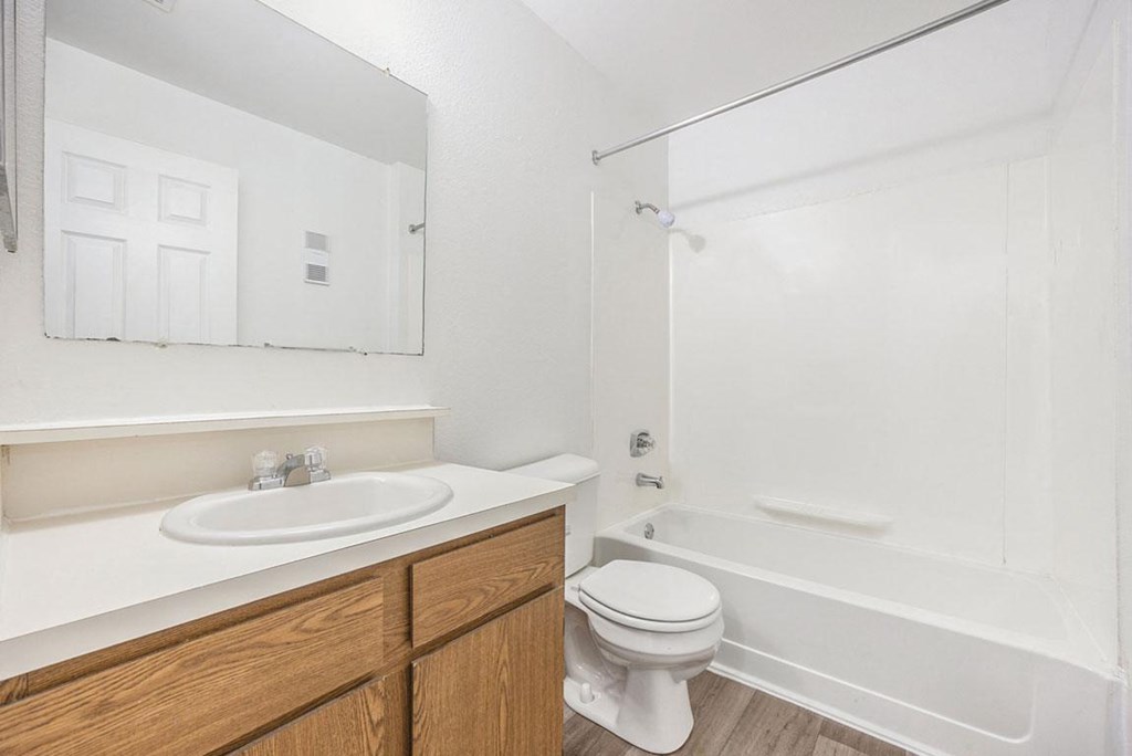 a bathroom with a sink toilet and a bath tub at Hampton Lakes Apartments, Michigan, 49534