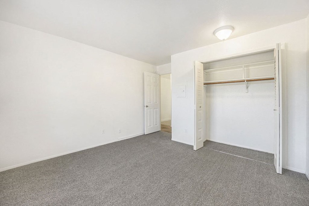 bedroom with a closet and plush carpeting at Hampton Lakes Apartments, Michigan, 49534