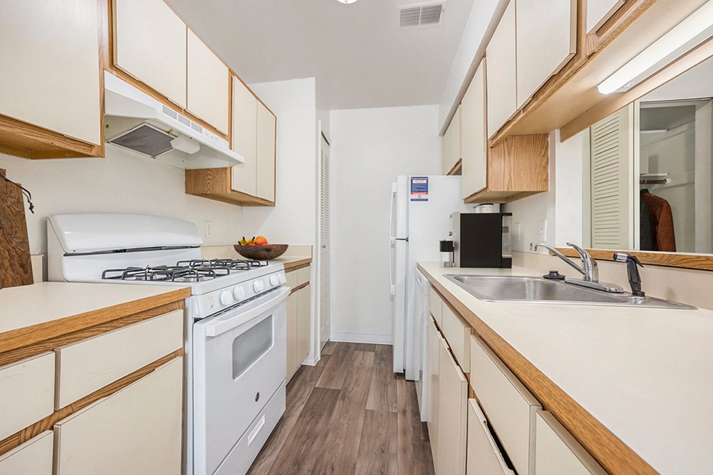 a kitchen with dishwasher and gas stove at Hampton Lakes Apartments, Michigan, 49534