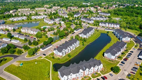 Aerial view of residential community with ponds and townhomes at Heatherwood Apartments, Michigan