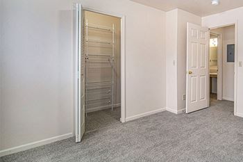 a bedroom with a walk in closet with organizers at Hurwich Farms Apartments in South Bend, IN