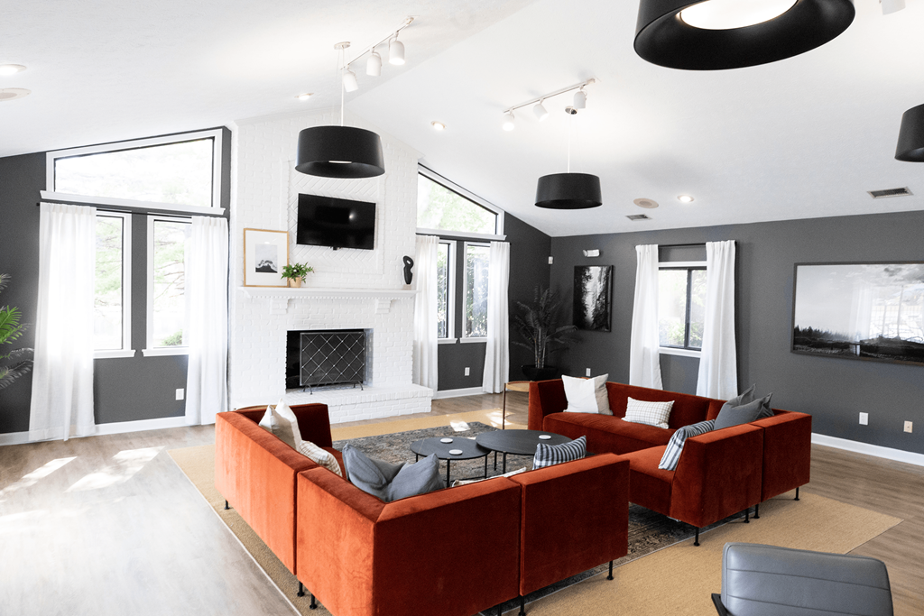 a living room with a fireplace and couches at Bavarian Village Apartments, Indiana