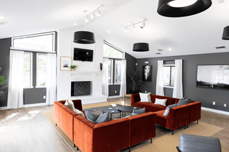 a living room with a fireplace and couches a living room with a fireplace and couches