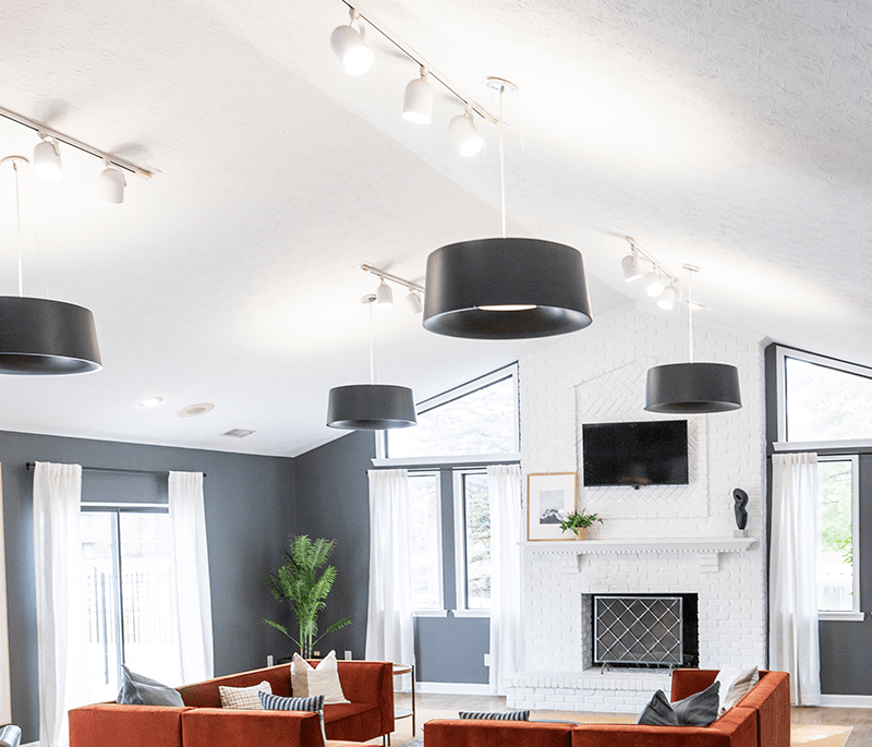 a living room with a glass table and chairs a living room with a glass table and chairs