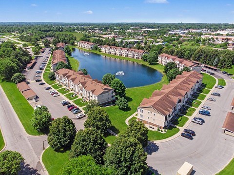 A lake is surrounded by apartment buildings.