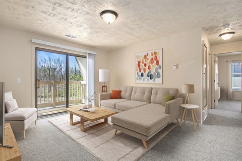 A living room with a couch, a coffee table, and a painting on the wall.