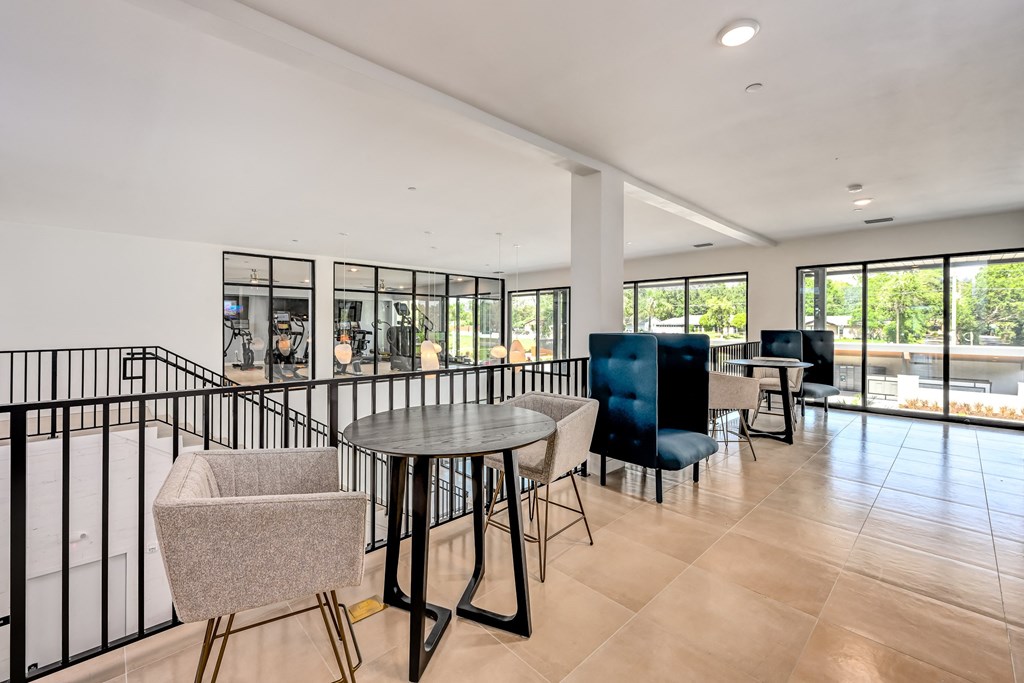 a room with a table and chairs and a pool in the background at Ironwood Flats, Brandon