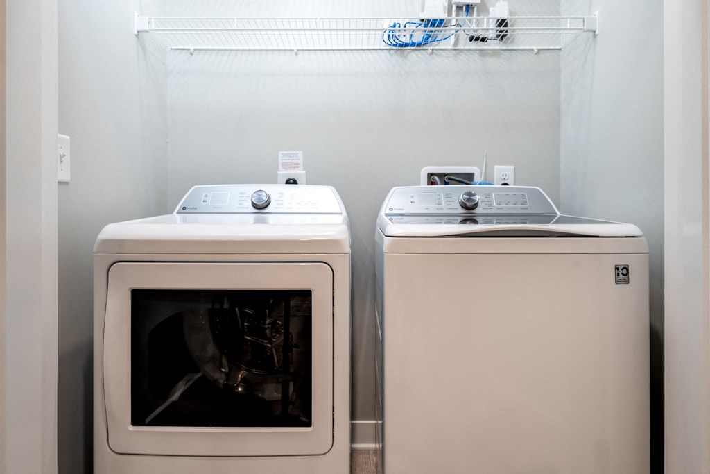 a washer and dryer sit next to each other in a laundry room at Ironwood Flats, Florida
