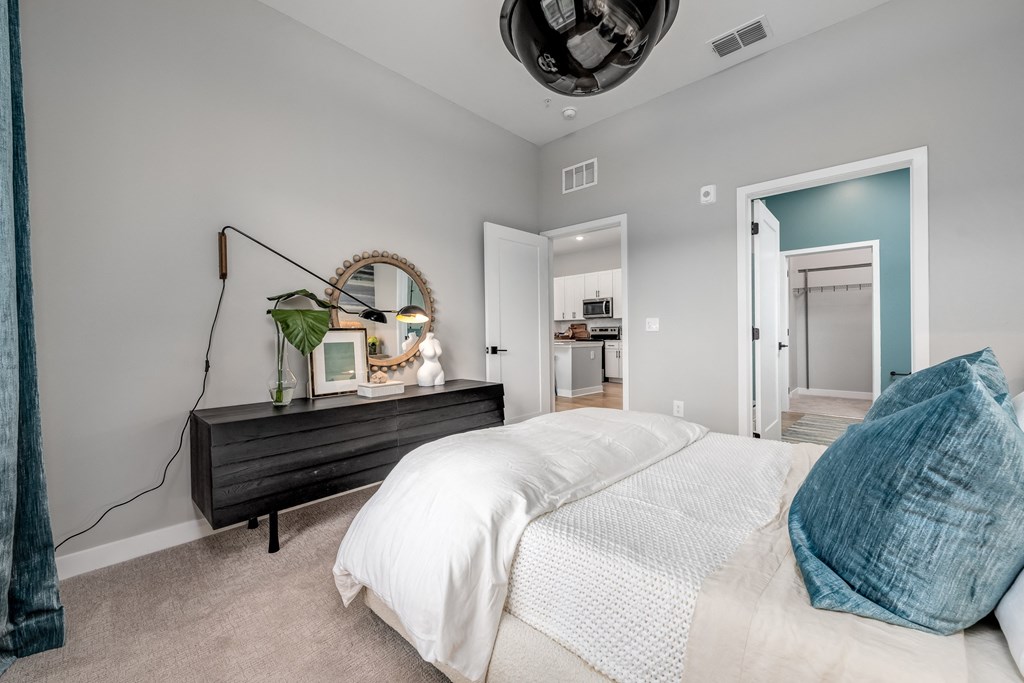 a bedroom with grey walls and a white bed at Ironwood Flats, Brandon, FL