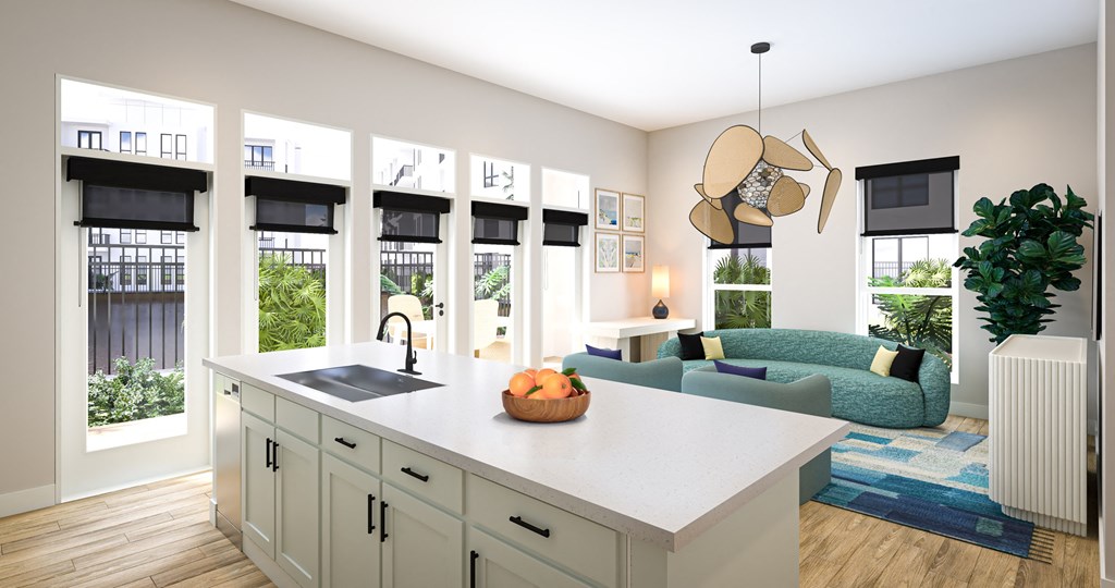 an open concept kitchen and living room with a blue couch and a white island with a sink at Ironwood Flats, Brandon, Florida