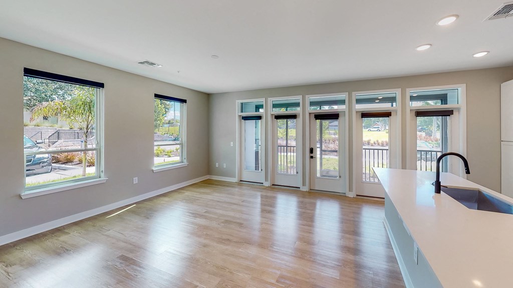 an empty living room with windows and doors at Ironwood Flats, Florida
