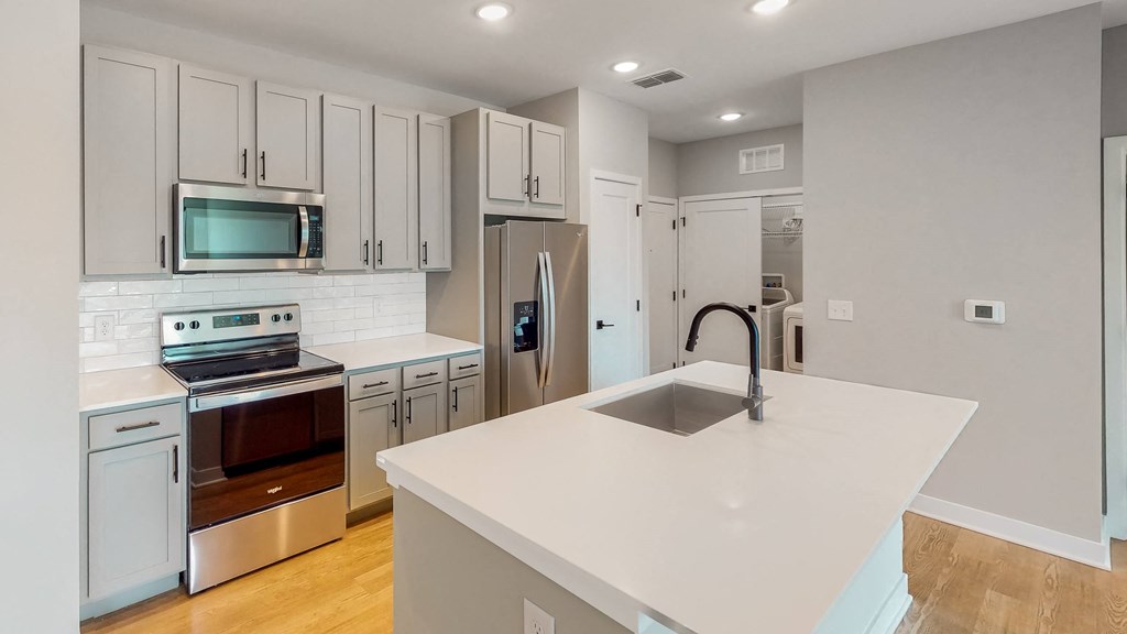 a kitchen with white cabinets and a white counter top  at Ironwood Flats, Florida