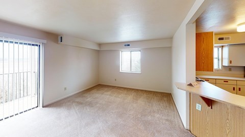 An enlarged living room with a window and sliding glass doors at Liberty Mills Apartments, Fort Wayne