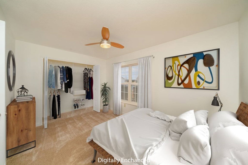 a bedroom with a bed, a ceiling fan and a closet with organizers a bedroom with a bed, a ceiling fan and a closet with organizers at Limestone Creek Apartment Homes, Madison, AL
