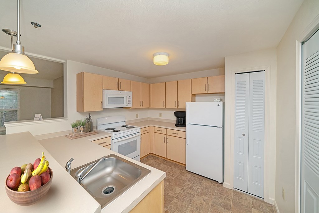 a kitchen with white appliances and a pantry at Limestone Creek Apartment Homes, Madison, AL