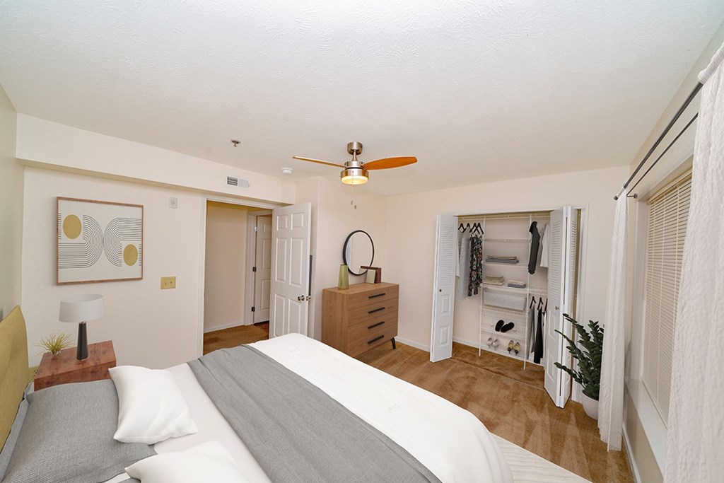 a bedroom with a bed and a ceiling fan at Limestone Creek Apartment Homes, Madison, AL