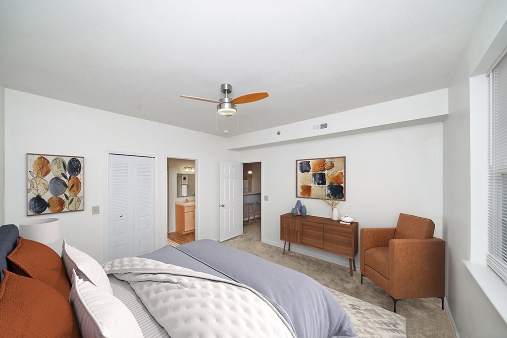 bedroom with a bed and a ceiling fan with attached bathroom at Limestone Creek Apartment Homes, Madison, AL