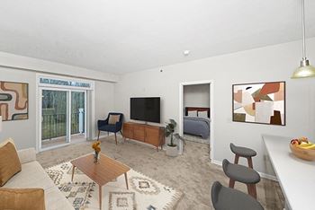 living room with a 9 foot ceiling to a private balcony at Limestone Creek Apartment Homes, Madison, Alabama, 35756