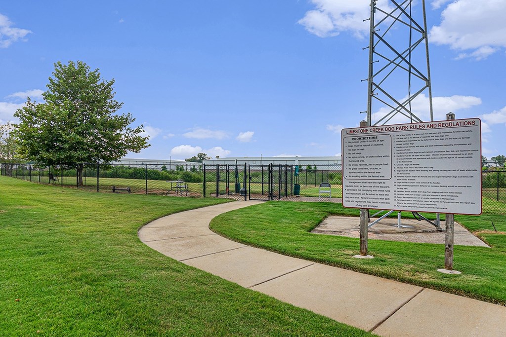 A dog park with a sign at Limestone Creek Apartment Homes, Madison, AL