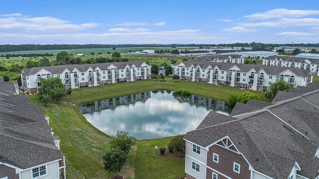 Peaceful pond views behind apartment buildings at Limestone Creek Apartment Homes, Madison, AL