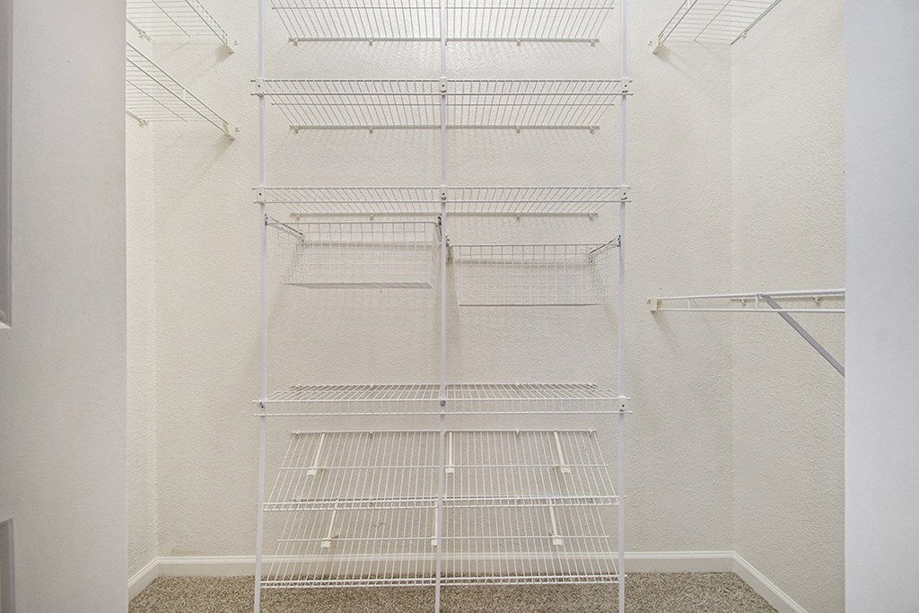 A walk in closet with wardrobe organizers at Lynbrook Apartments and Townhomes, Elkhorn, NE, 68022
