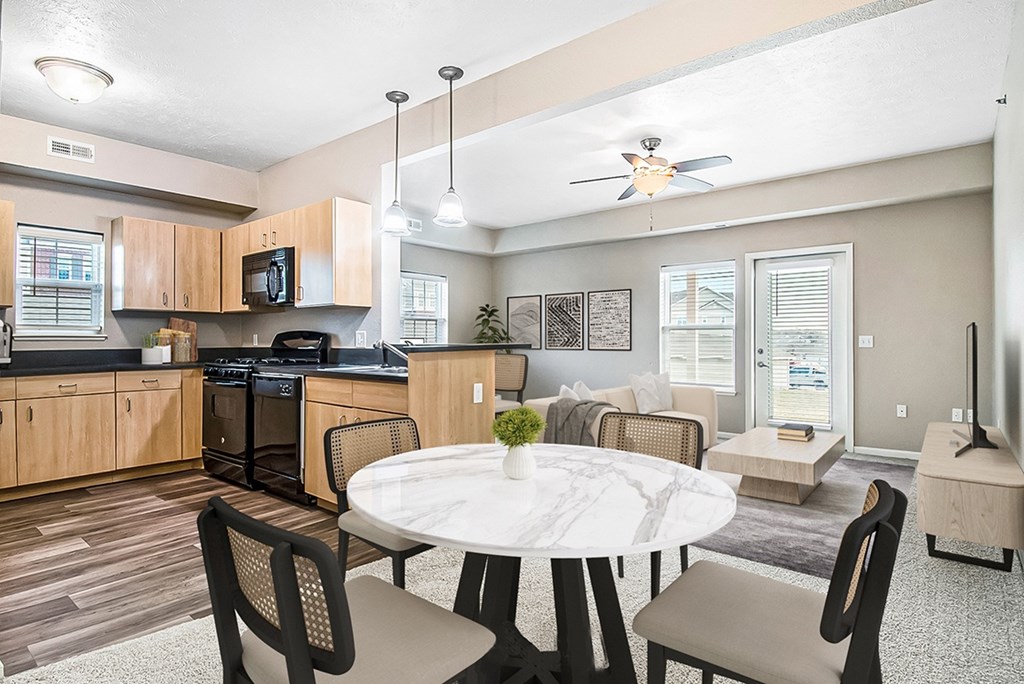 A kitchen with a window, and living room with a ceiling fan at Lynbrook Apartments and Townhomes, Elkhorn, NE, 68022
