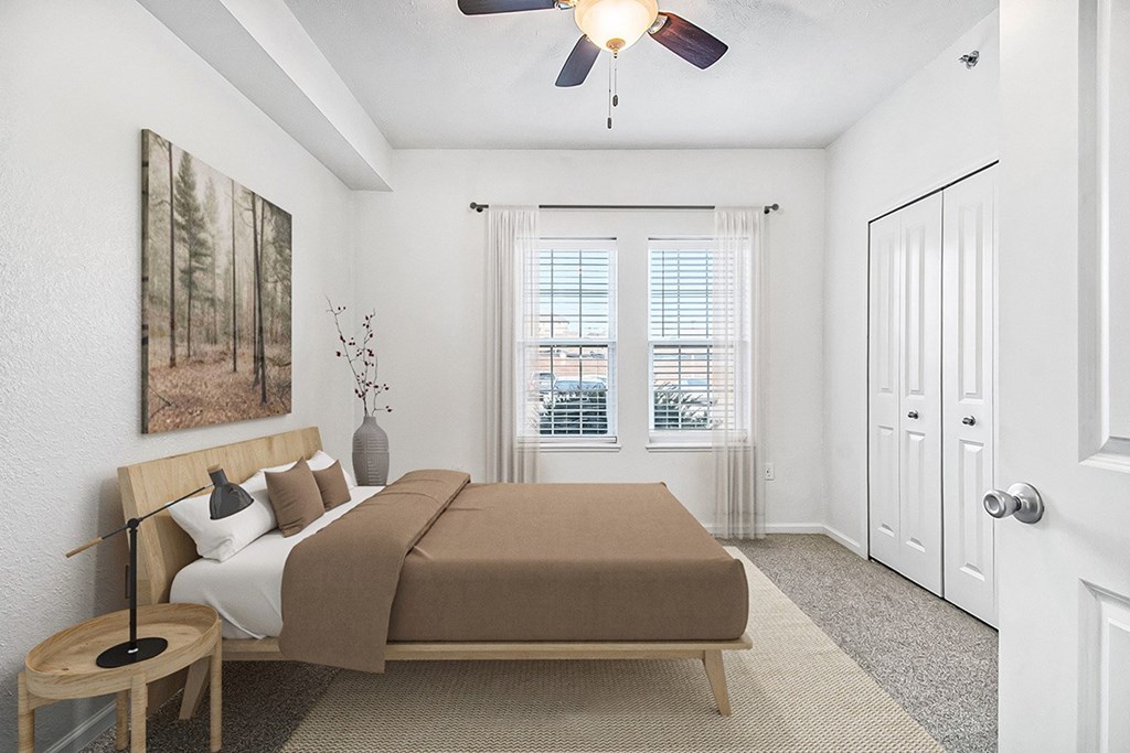 A bedroom with large windows and a ceiling fan at Lynbrook Apartments and Townhomes, Elkhorn, NE, 68022