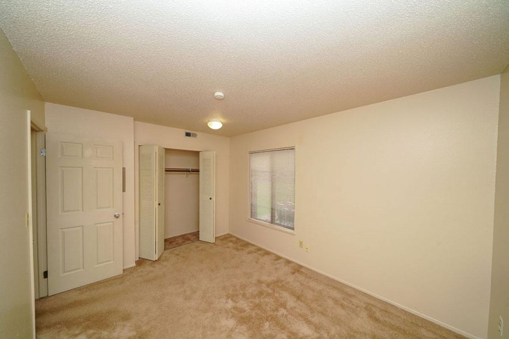 Spacious Bedroom with Large Window at Madeira Apartments in Kalamazoo, MI