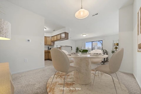 A dining room with a table and chairs.