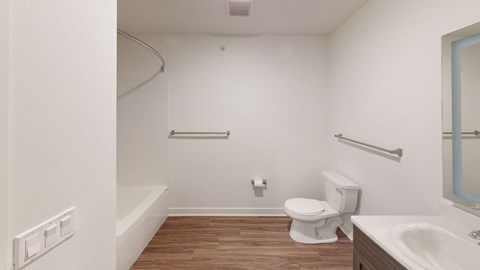 A white bathroom with a toilet, sink and bathtub.