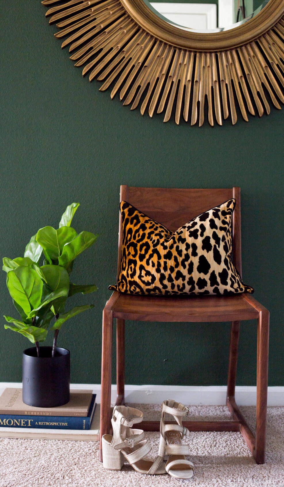 a chair with a leopard pillow and a plant on the side  at Enclave Apartments, Midlothian, VA
