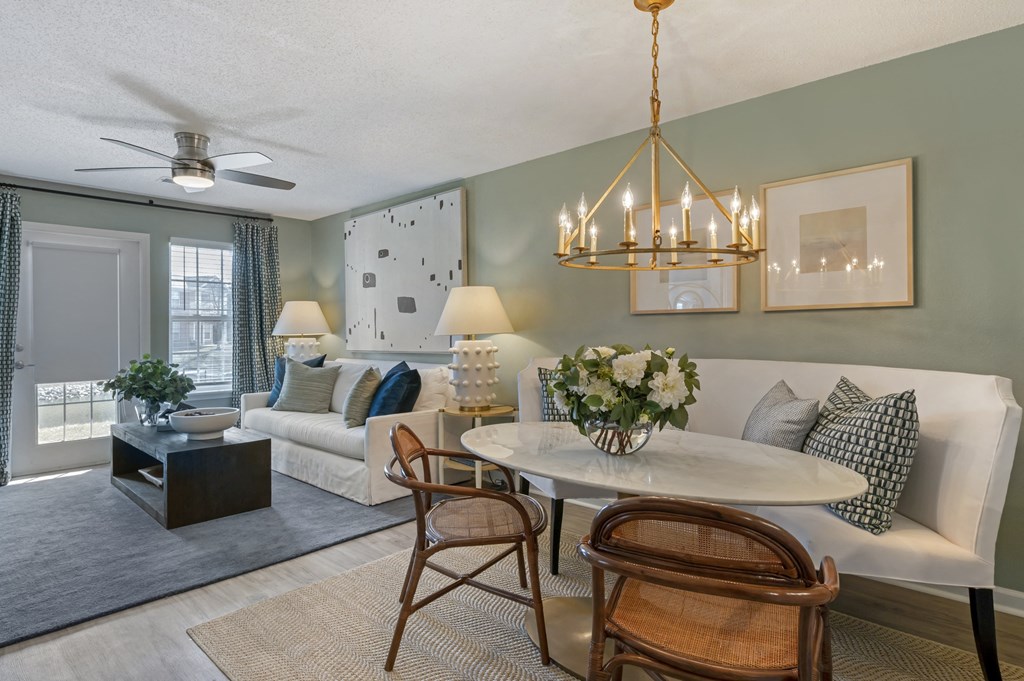 a living room filled with furniture and a chandelier at Latitudes Apartments, Indiana