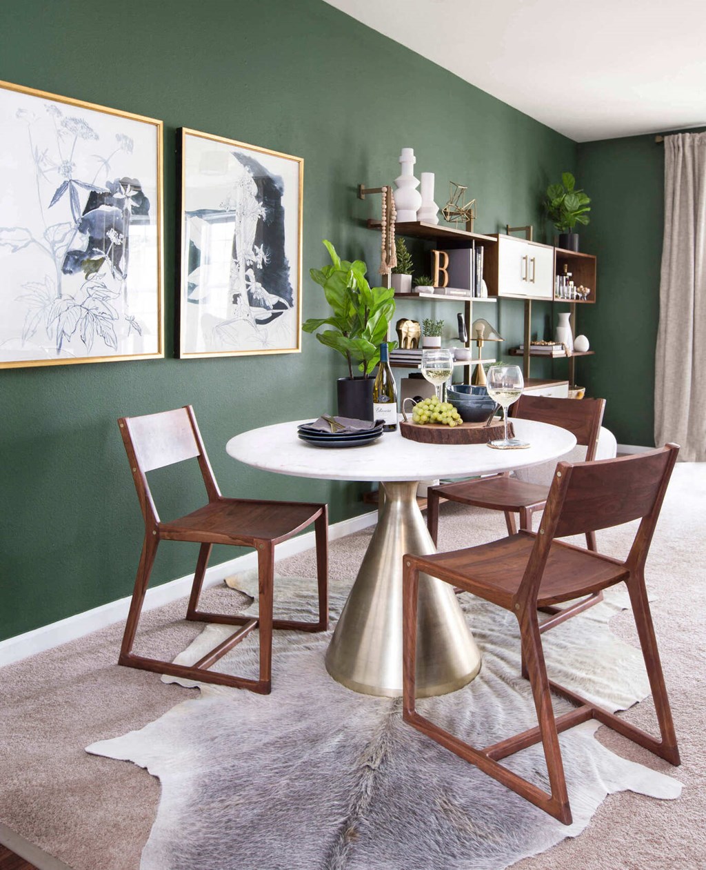 a dining room with green walls and a white table and chairs  at Enclave Apartments, Midlothian, Virginia