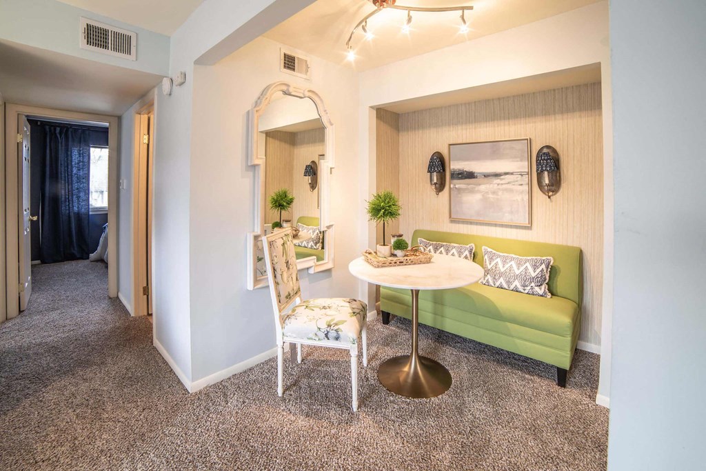 a living room with a green couch and a white table at Pheasant Run, Lafayette, 47909