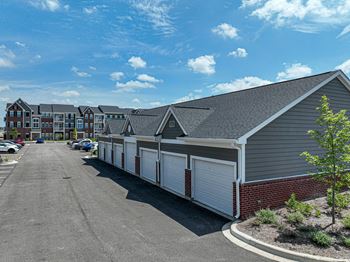 a row of garages with a blue sky in the background at Montgomery Place Apartments, Illinois, 60538