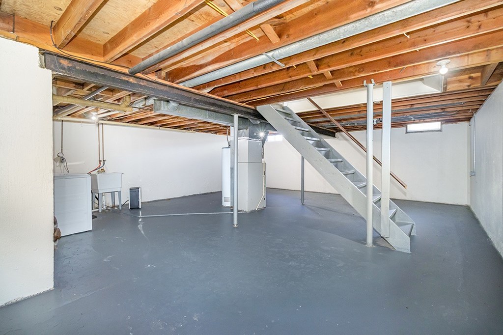 A basement with a washer and dryer along with lots of storage space at Mount Royal Townhomes, Michigan