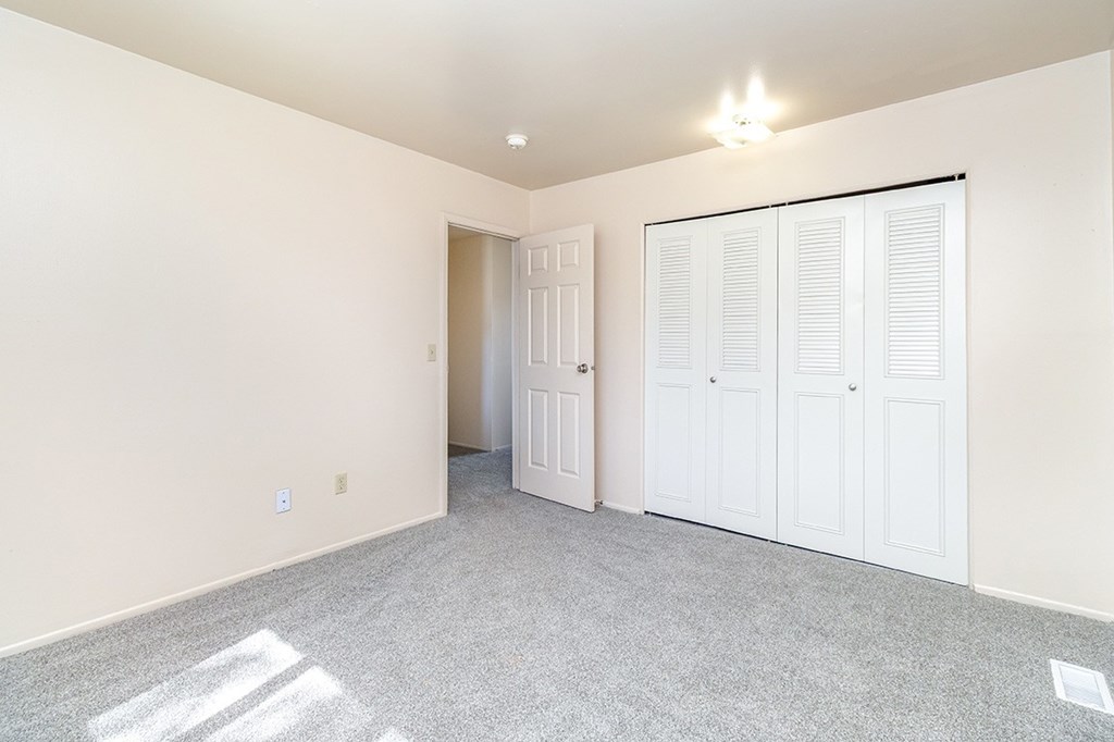 A bedroom with a large closet at Mount Royal Townhomes, Michigan