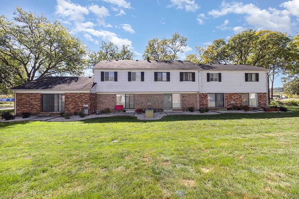 A brick exterior building rear view with patios at Mount Royal Townhomes in Kalamazoo, MI