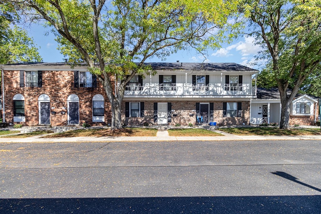 A townhome building with trees in front at Mount Royal Townhomes in Kalamazoo, MI