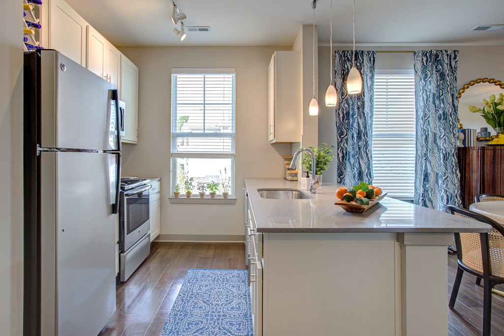 a kitchen with white cabinets and stainless steel appliances  at Avellan Springs Apartments, North Carolina