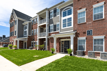 a large brick building with a grassy area in front of it at 24 at Bloomfield, Bloomfield Township, 48302